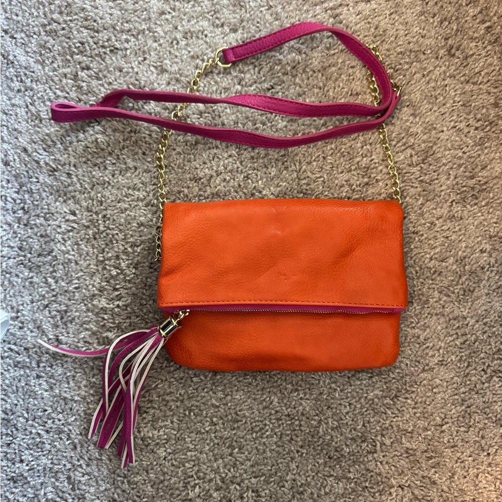 Orange purse with pink trim and gold hardware